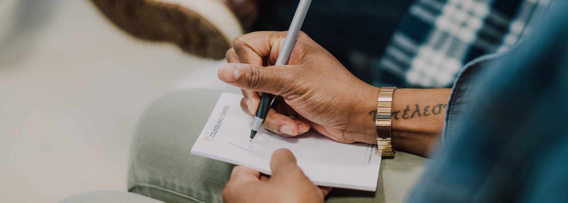 a man writing notes in a group session at Freehold